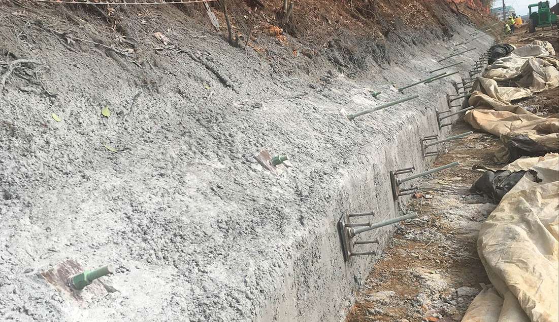 A steel plate and nut is added at the face to connect the shotcrete to the soil nails.