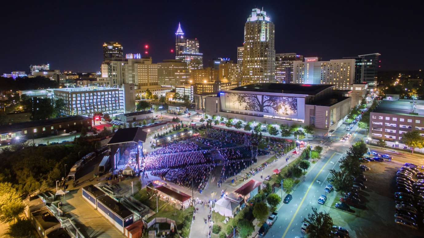 Music concert and downtown skyline at night