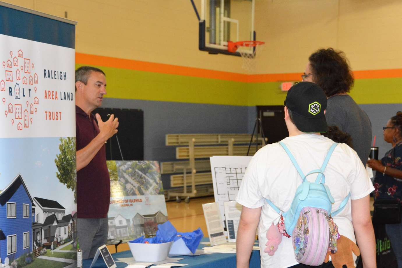 Photo of event attendees talking with representative from Raleigh Area Land Trust