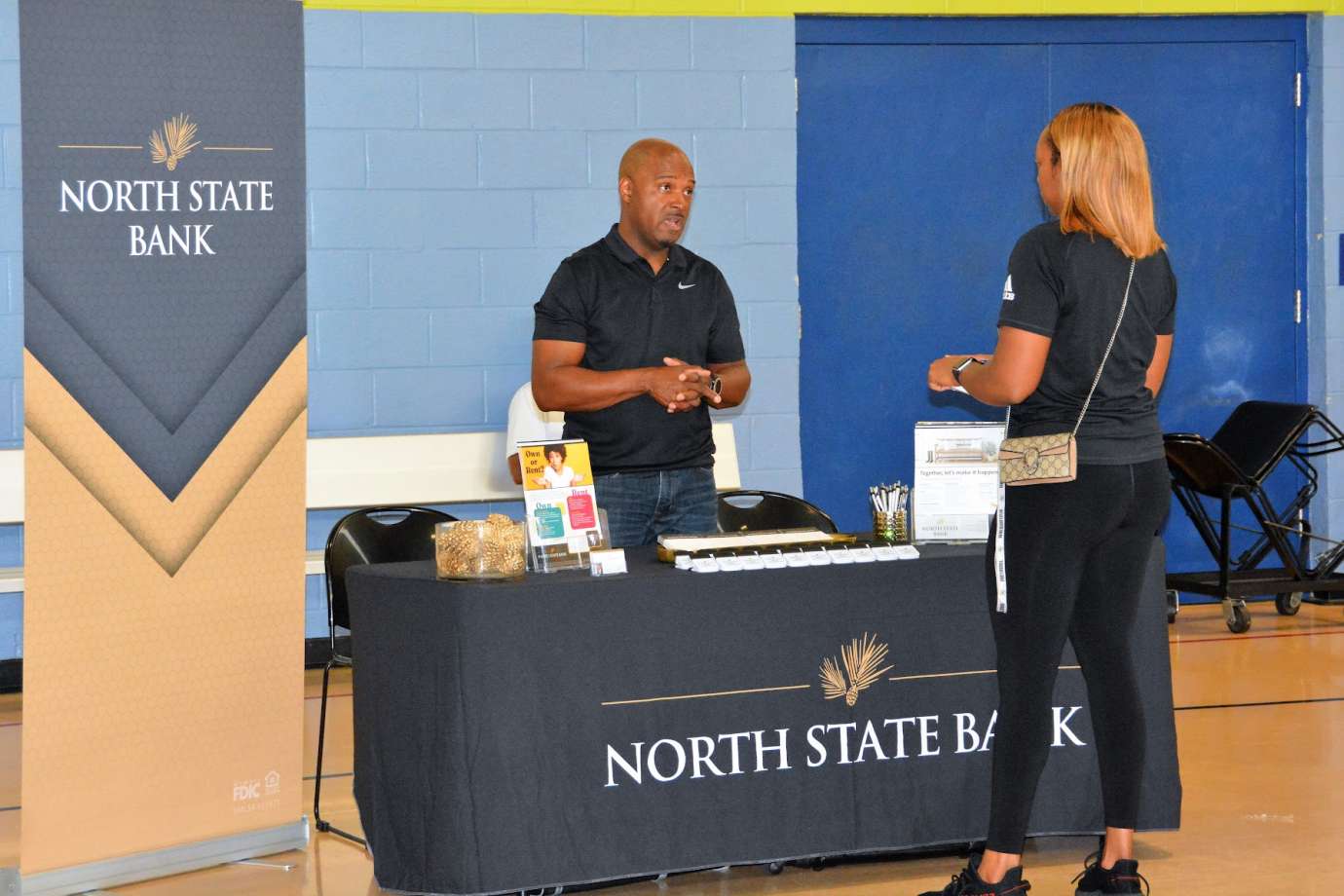 Photo of event attendees talking with representative from North State Bank