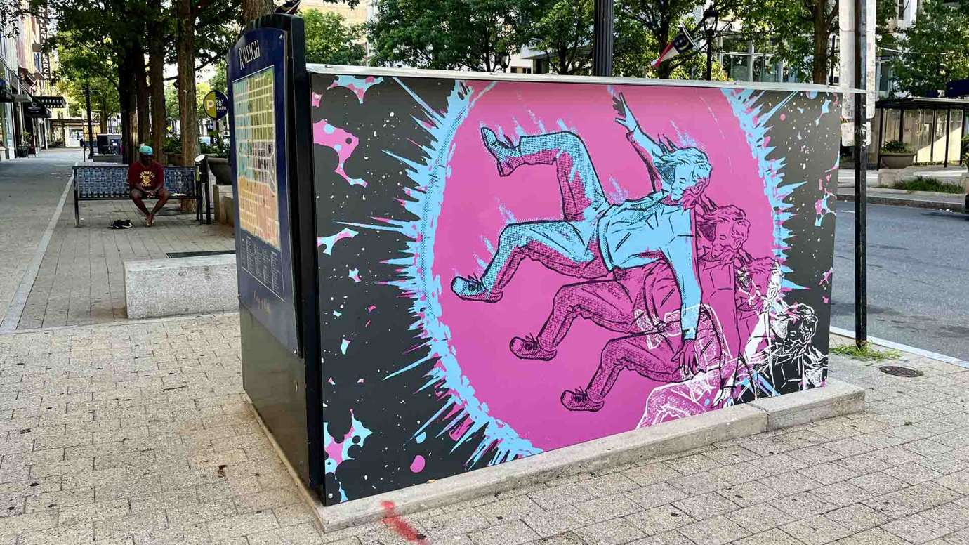 Artwork on a news kiosk on Fayetteville Street by Christopher Williams