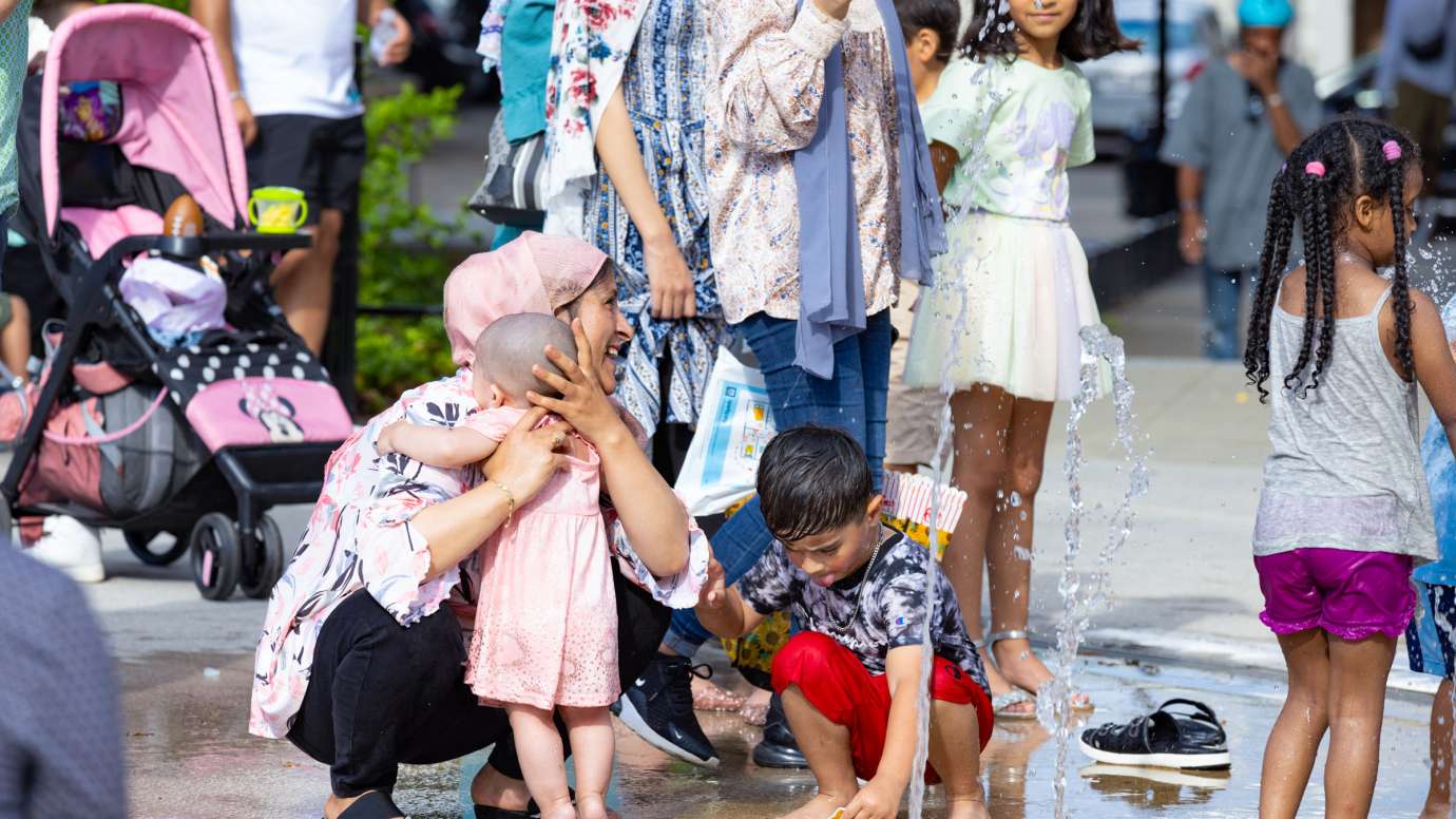 a family at splash while mother hugs baby