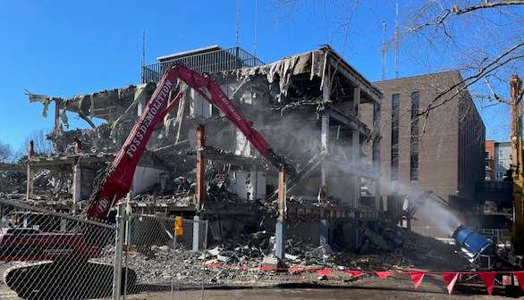 large equipment taking down inner walls of the old police station, photo taken from McDowell St side of building  