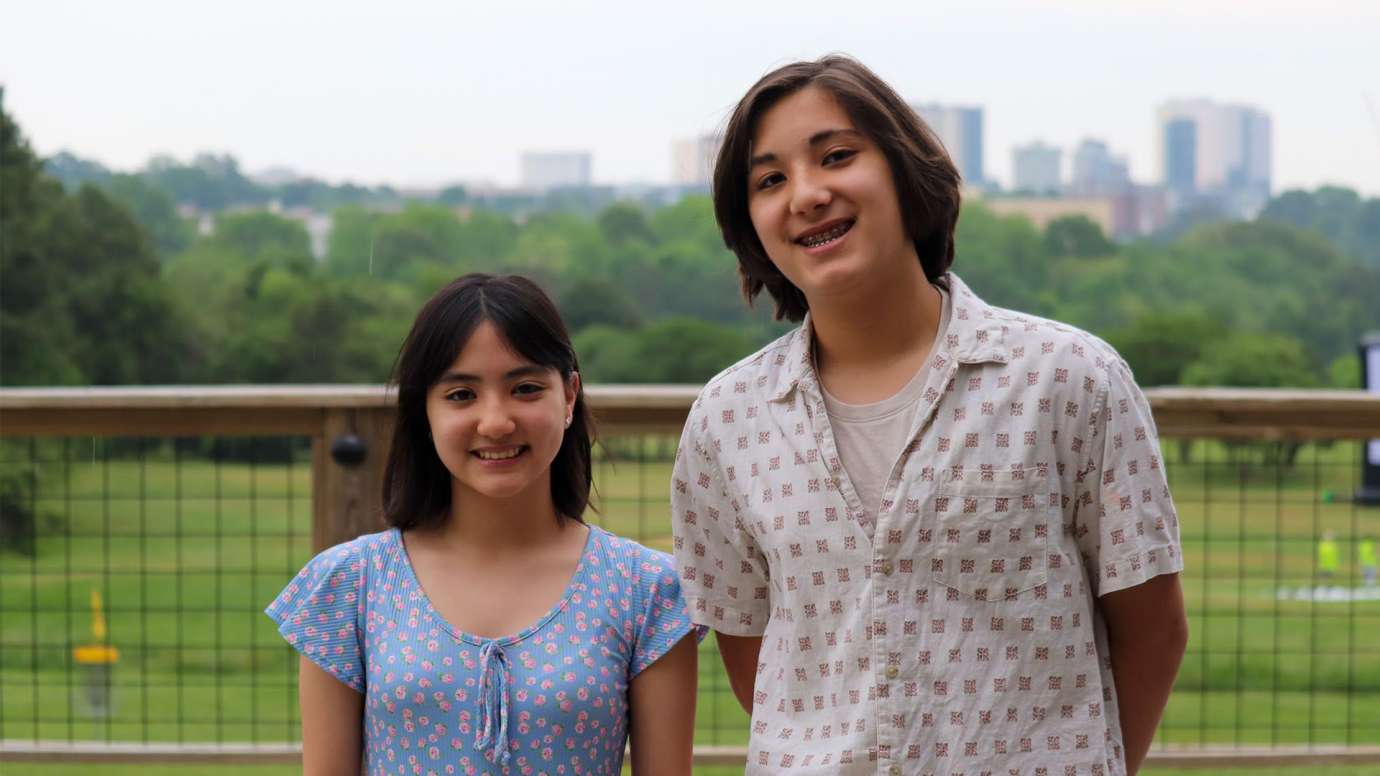 Rhys Price and Jayda Price pose in front of Raleigh skyline.