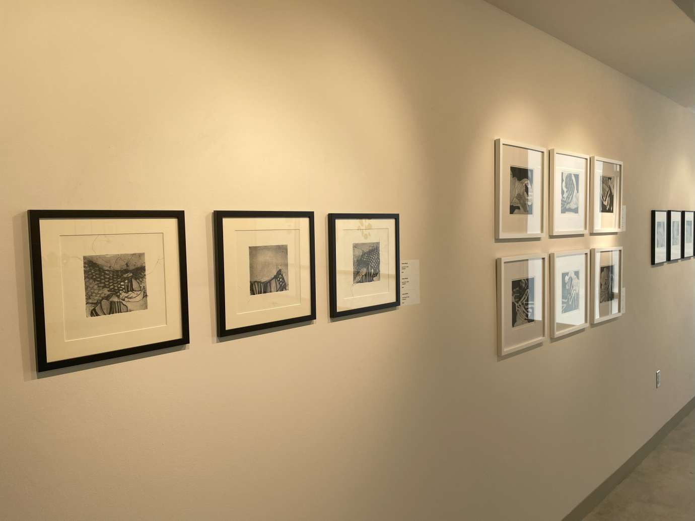 Gallery wall with groupings of framed works on paper