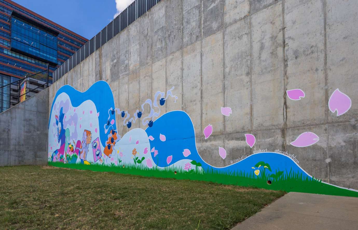 Colorful mural on a cement wall featuring an undulating wave figure