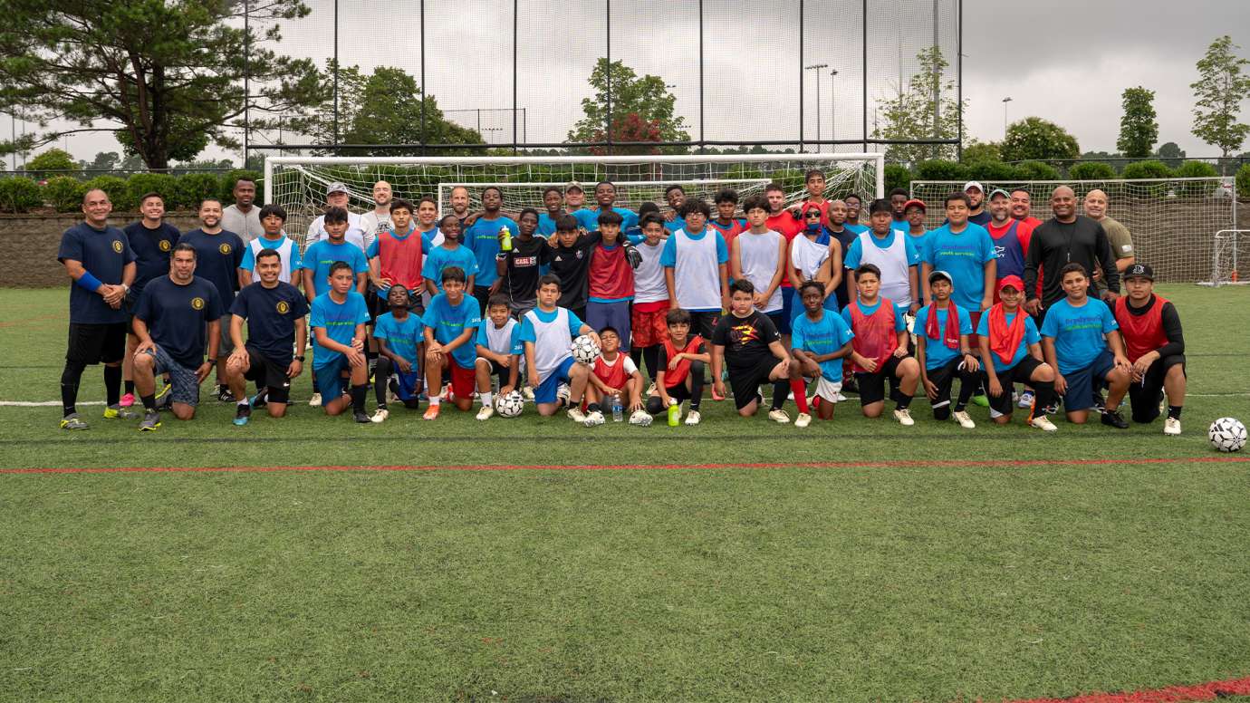 Group photo of officers and soccer team