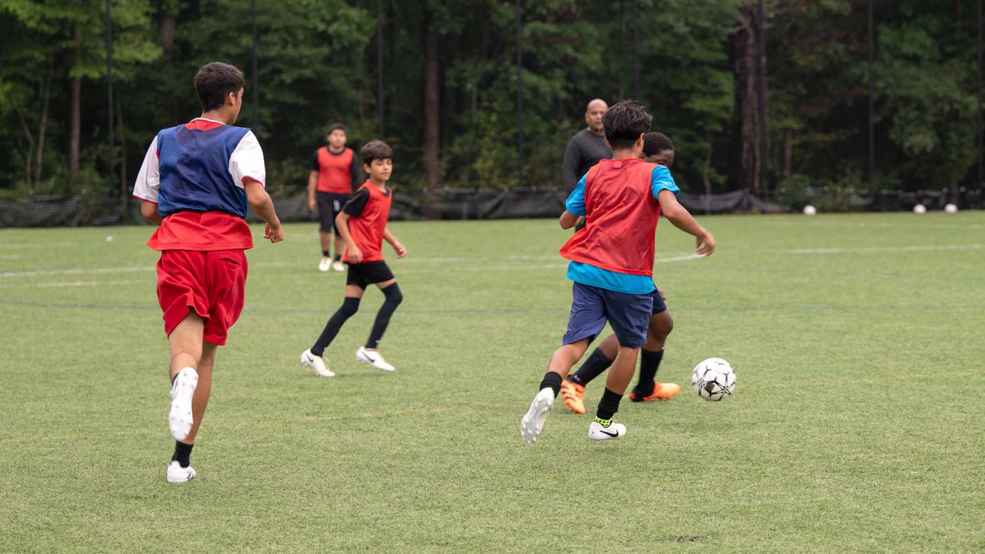 Soccer players playing soccer at police summer camp