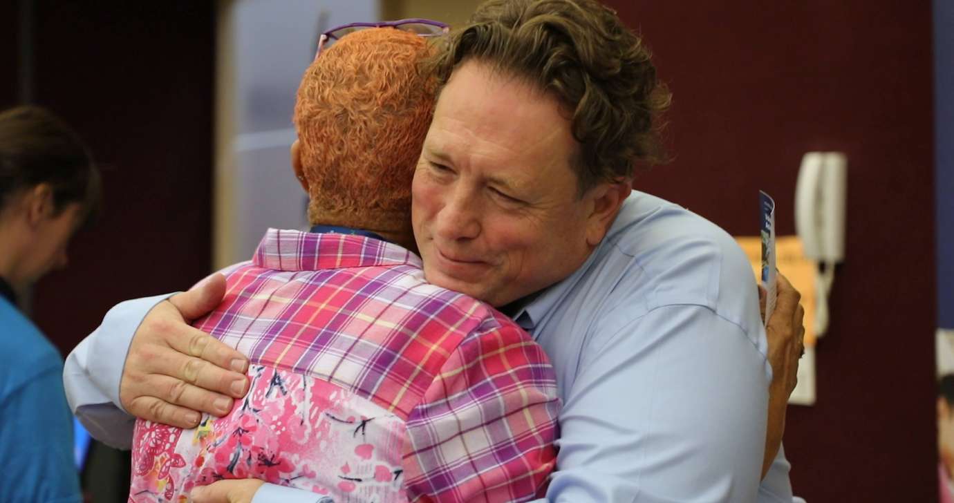 Dan Bagley hugs a Raleigh resident during the expo