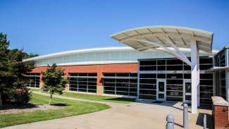 Front view of the red brick and glass Barwell Road Community Center