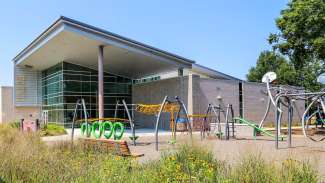 playground with monkeybars and other climbing equipment at the front of the Halifax Community Center