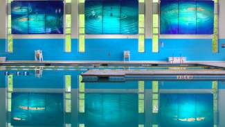 reflection of public art hanging above pool 