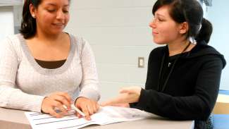 Two women registering for ESL classes