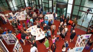 people gathered in lobby to view student artwork