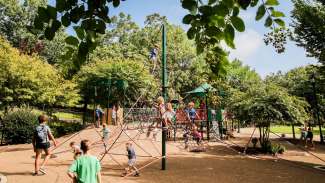 kids playing on climbing equipment at Pullen Park