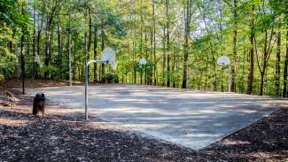 Outdoor basketball court with four baskets at Cedar Hills Park 