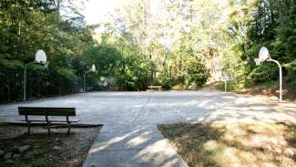 Outdoor basketball court with multiple hoops at Glen Eden Pilot Park