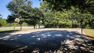 Shot of the two outdoor basketball courts and hoops at Green Road Park 