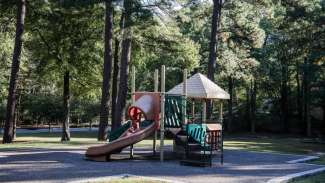 Playground with rubber surface and slide at Kentwood Park. 