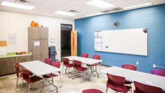 A second multi-purpose room at Sanderford Road with a white board, tables and chairs