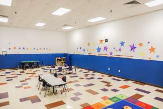 A second classroom with tables and chairs 