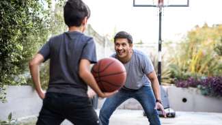 Dad and son playing basketball