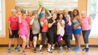 A group of active adults following an exercise glass 