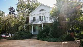 A white home-looking structure which serves as the business office for School Programs, Nature Programs, and Teen Programs.