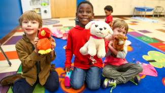 A group of young kids participating in a preschool program 