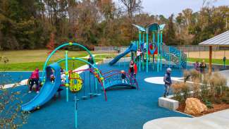 A large outdoor playground with many climbing surfaces