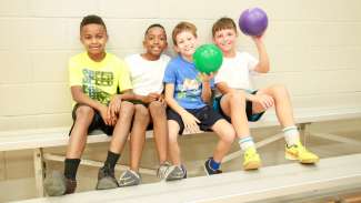 Kids smiling and hanging out during a summer camp