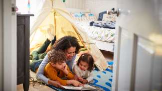 Family reading inside together