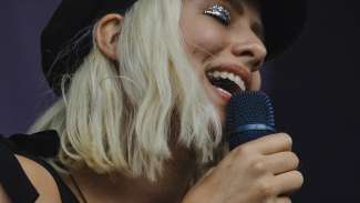 woman singing into a microphone