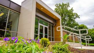 Front doors of Biltmore Hills Community Center with purple flowers