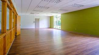 View of meeting room one with wood floors and big windows