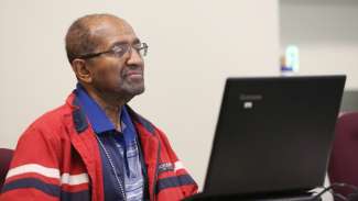 A man working on a computer during a class 