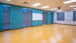 A large open meeting room with a mounted white board 