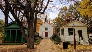 The village of Mordecai Historic Park in fall with leaves of color