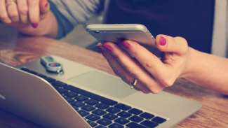 woman using laptop and smartphone