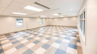 Interior view of tiled meeting room with windows