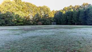 Green open space of grass with two metal goals