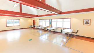 A large, open meeting room with tables and chairs 