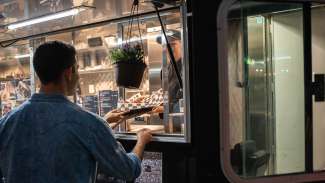 A person ordering at a food truck