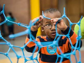 Child plays with display at Marbles Kids Museum