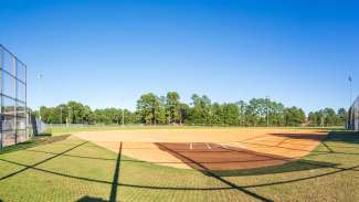 Baseball field with trees in distance