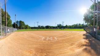 Baseball field with trees in distance