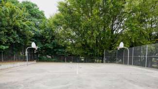 Basketball court with trees in background