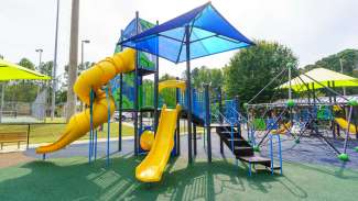 Playground equipment with climbing structures in background