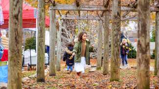 children playing outside at Mordecai in coats