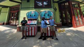 carnival game in front of carousel 